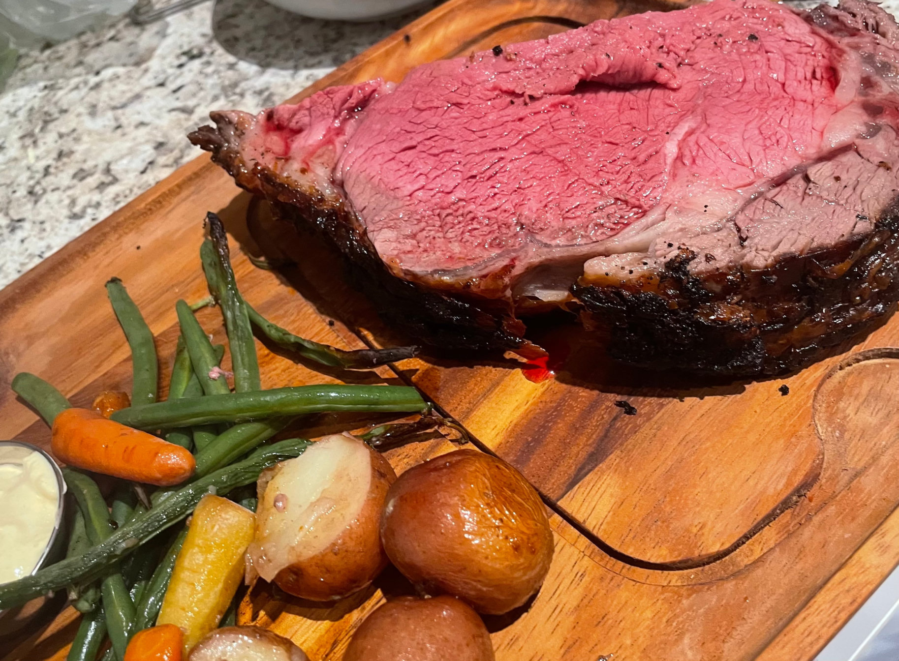 Prime rib with roasted potatoes and vegetables
